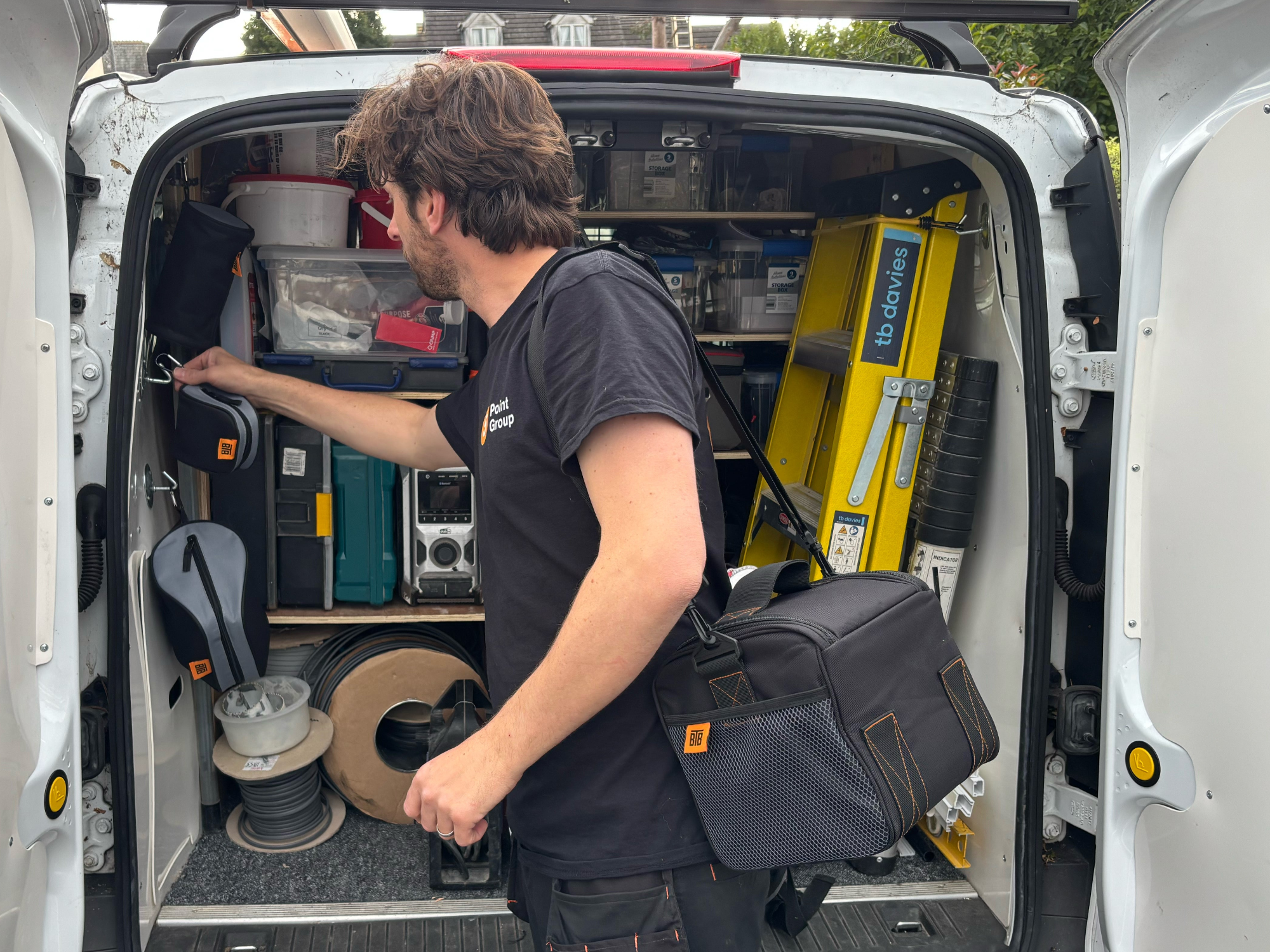 Tradesman carrying bag which contains travel kettle, cups and tea making kit.